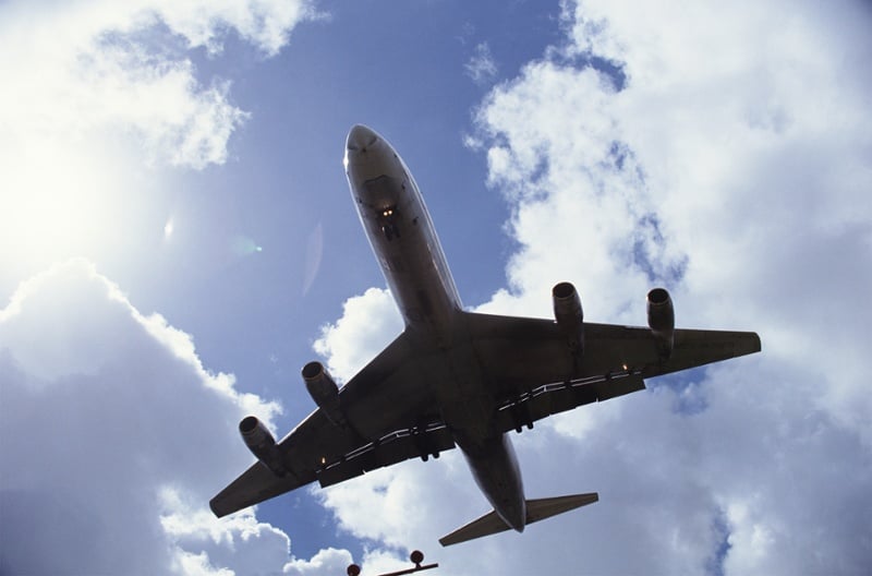 plane flying in cloudy sky